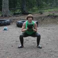 Kyykkyä kahvakuulan kanssa metsäkuntosalilla.